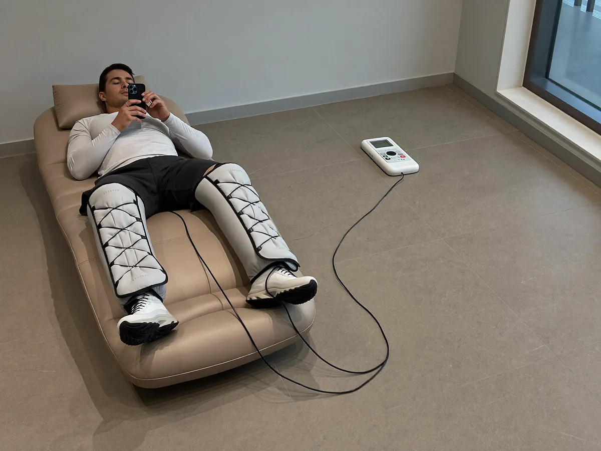 Normatec 3 (Hyperice) in use with a client in a modern Indonesian wellness clinic